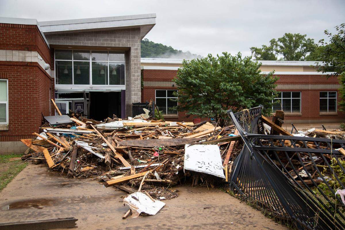 Piles of debris sits outside the Buckhorn School after flooding swept through Buckhorn in Perry County, Ky., Friday, July 29, 2022.
