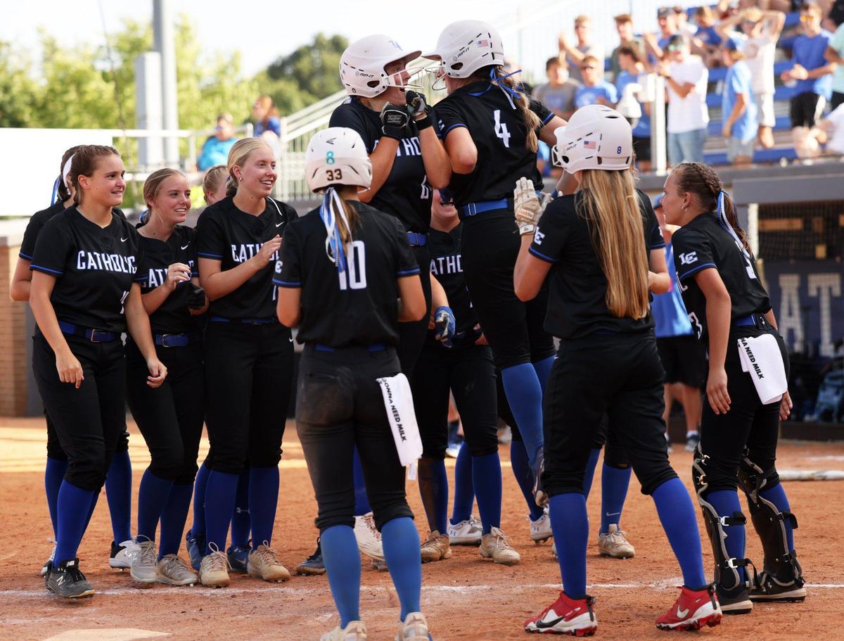 Lexington Catholic’s Ava Emmert, left, and Abby Hammond (4), jumped to celebrate Emmert’s second three-run home run of the game in the third inning of their state tournament game against Montgomery County.