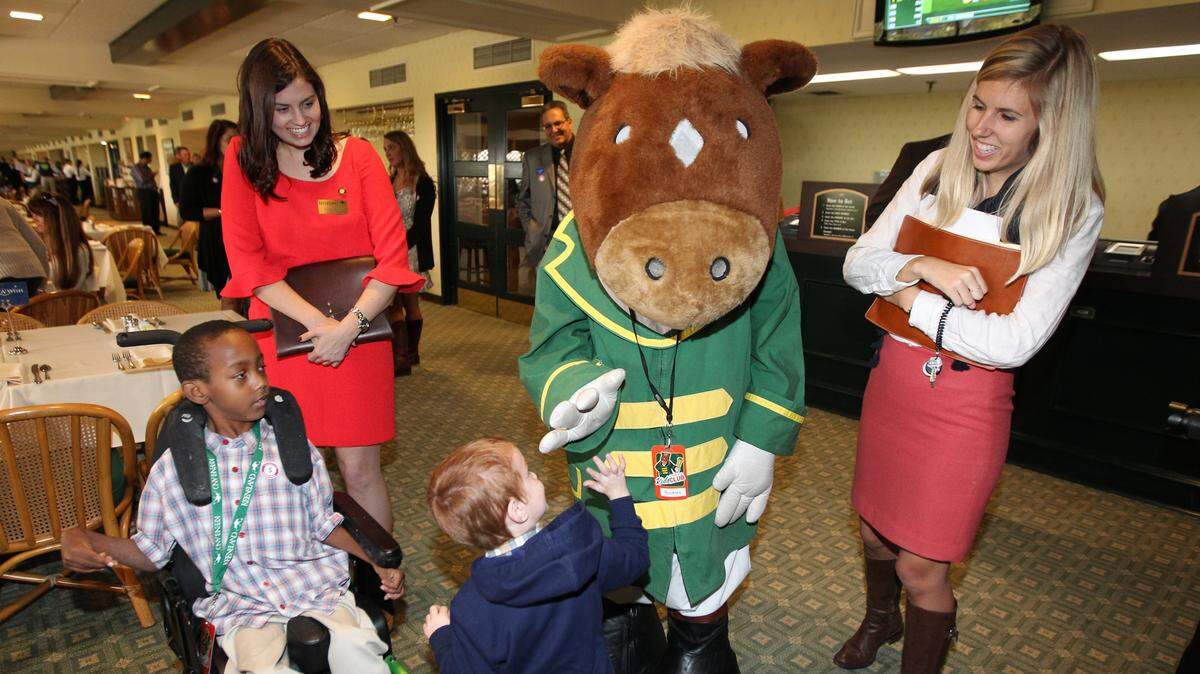 Hayley Robic, right, interacted with children as part of her community outreach role when she worked at Keeneland Race Course. The University of Kentucky graduate and daughter of Wildcats assistant basketball coach John Robic, has died at age 27 after a battle with cancer.