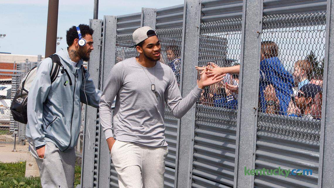 Willie Cauley-Stein and Karl-Anthony Towns slapped hands with fans Sunday as the Kentucky basketball team arrived at Blue Grass Airport.
