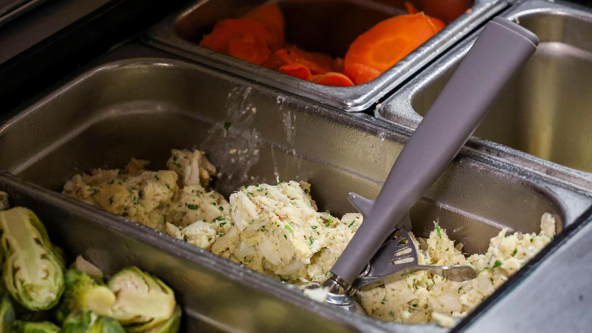 Tony’s of Lexington’s Jumbo Lump Crab Cake mixture is made daily in large batches and then placed on a baking sheet using a 4 oz. ice cream scoop. Each crab cake gets two scoops of the crab mixture.