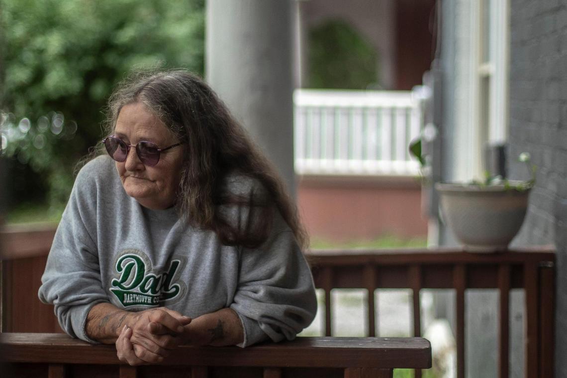 Nancy Cox, 61, of Lexington, poses for a portrait outside her new apartment on Jefferson Street in Lexington, Ky., on Tuesday, Aug. 30, 2022. Cox, along with her neighbors, was evicted from a cheaper apartment in a building on North Limestone that is being renovated by new owner Shane Eckman, a major real estate investor. The city’s affordable housing office relocated Cox to her new apartment.