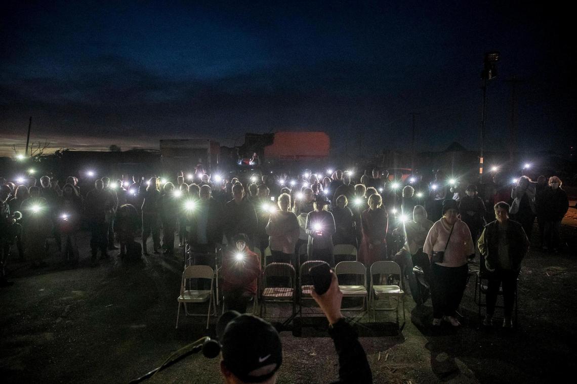 Members of Mayfield First Presbyterian Church and Mayfield First Christian Church gather in an empty lot between their destroyed church buildings for a joint Christmas Eve service in Mayfield. A tornado devastated the community on Dec. 10.