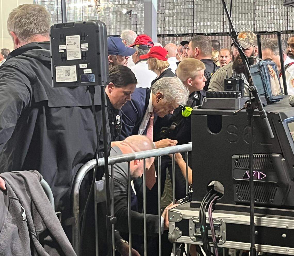 Dr. Mehmet Oz, along with medical personnel, helps a man who fainted during President Donald Trump’s speech in Hebron, Ky., Wednesday, March 11, 2026. It was the second medical incident during the rally. Oz is a physician and the administrator for the U.S. Centers for Medicare & Medicaid Services.