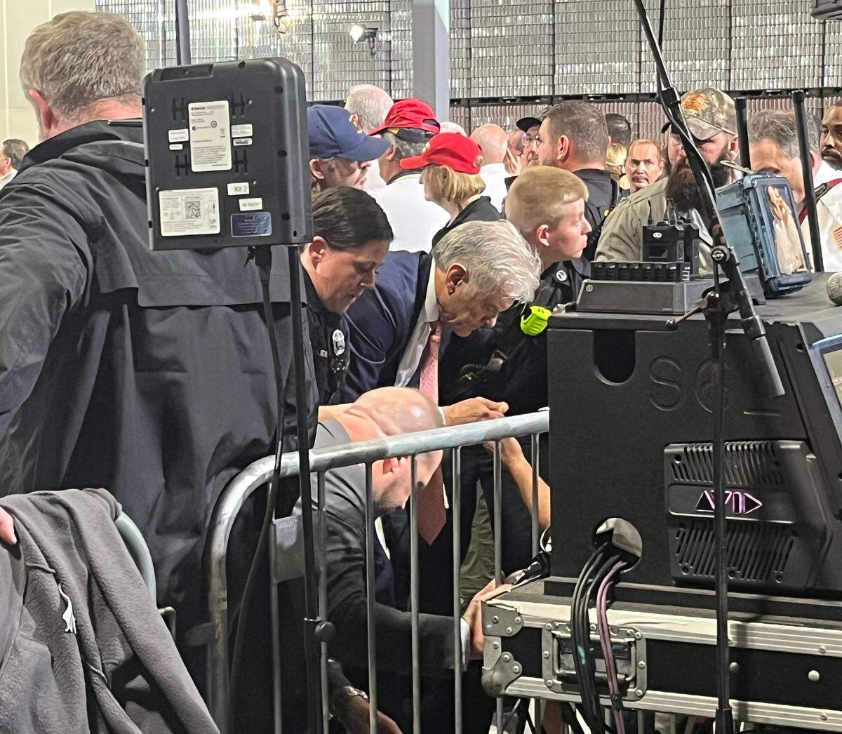 Dr. Mehmet Oz, along with medical personnel, helps a man who fainted during President Donald Trump’s speech in Hebron, Ky., Wednesday, March 11, 2026. It was the second medical incident during the rally. Oz is a physician and the administrator for the U.S. Centers for Medicare & Medicaid Services.