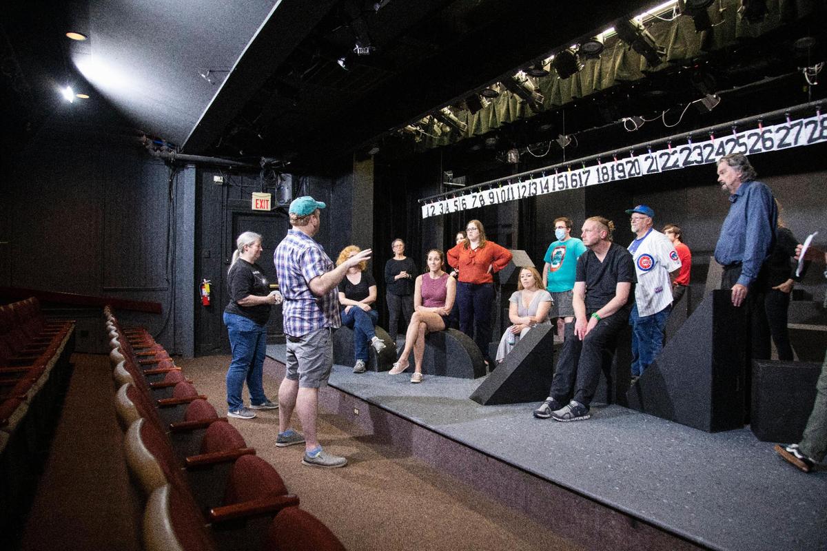 Director Steve Meadows talks with the cast of “Too Much Light Makes the Baby Go Blind” before beginning a dress rehearsal at the Carriage House in Lexington, Ky., Tuesday, May 10, 2022. The show is presenting 30 plays of around two minutes each in 60 minutes. The order of plays is chosen at random from pieces of paper hanging over the stage. It moves fast and is constantly changing. The plays are performed at random, as selected by the audience, so the actors never know what’s next.