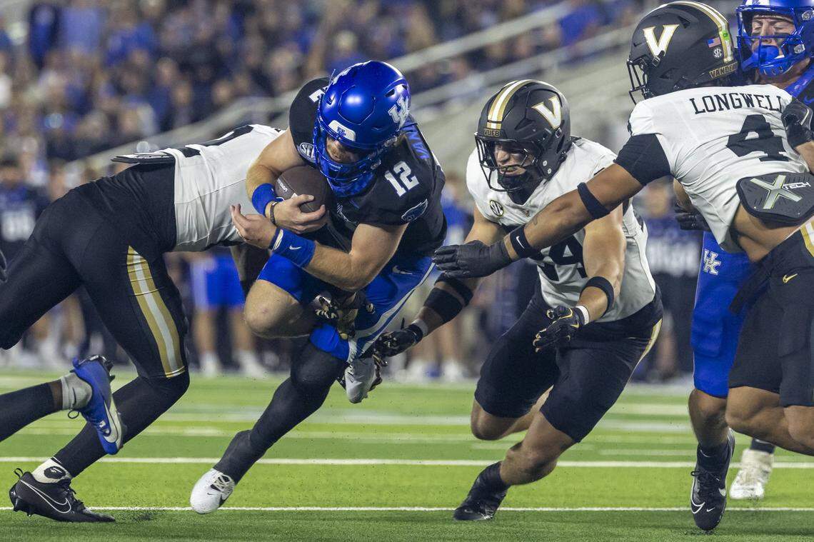 Kentucky quarterback Brock Vandagriff (12) runs the ball as Vanderbilt linebacker Nicholas Rinaldi (24) follows during Saturday’s game at Kroger Field.