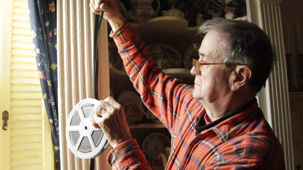At home in Nicholasville, Richard Smith looked through frames of a film reel for an old ad. Smith worked on Madison Avenue in the 1960s but grew tired of the grind.