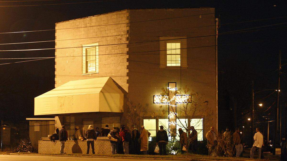 People line up as they wait to enter the Community Inn when the  doors open nightly at 7pm in Lexington, Ky., Thursday, November 21,  2013. Photo by Matt Goins