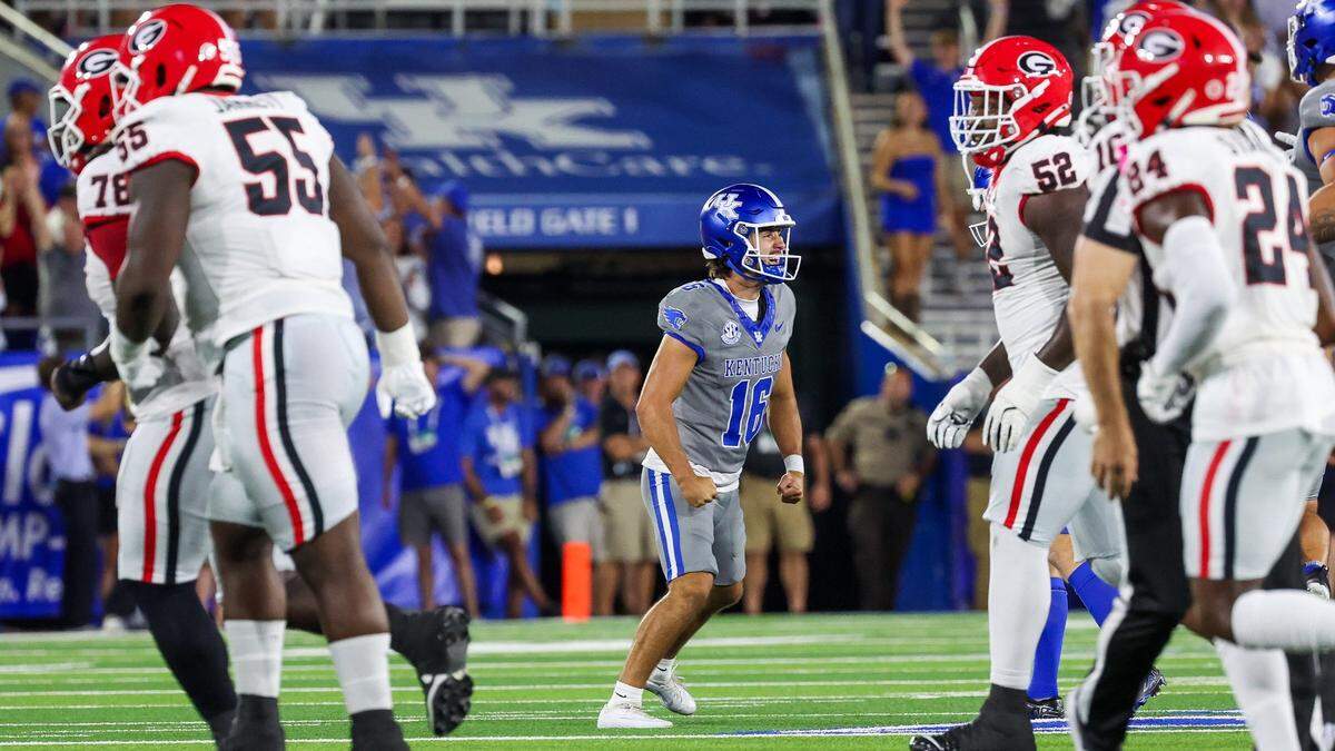 Kentucky place-kicker Alex Raynor, center, celebrates making one of his four successful field-goal attempts against Georgia on Saturday.