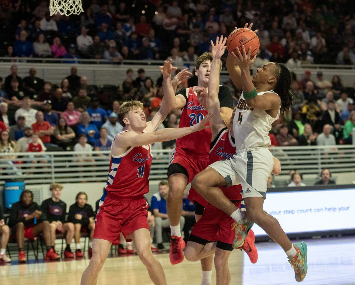Frederick Douglass point guard Dakari Talbert, right, drives in against Madison Central’s Joseph Powers (11) and Jake Feldhaus (20) in the Broncos' 58-29 win in the boys 11th Region Tournament semifinals on Saturday at Eastern Kentucky University’s Baptist Health Arena in Richmond.