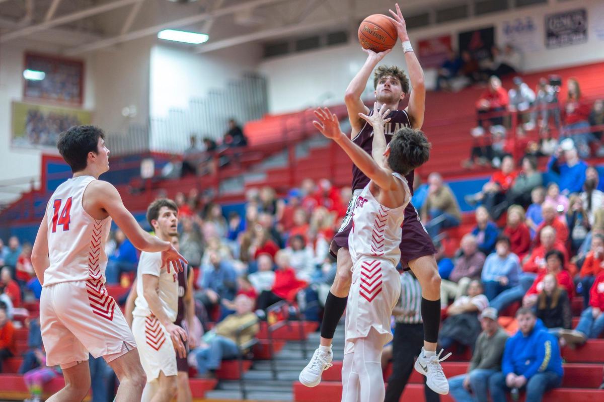 Ashland Blazer’s Zander Carter shoots the ball over Lincoln County’s Lane Sergent during the Tomcats’ 78-23 win at Lincoln County High School in Stanford on Jan. 17.
