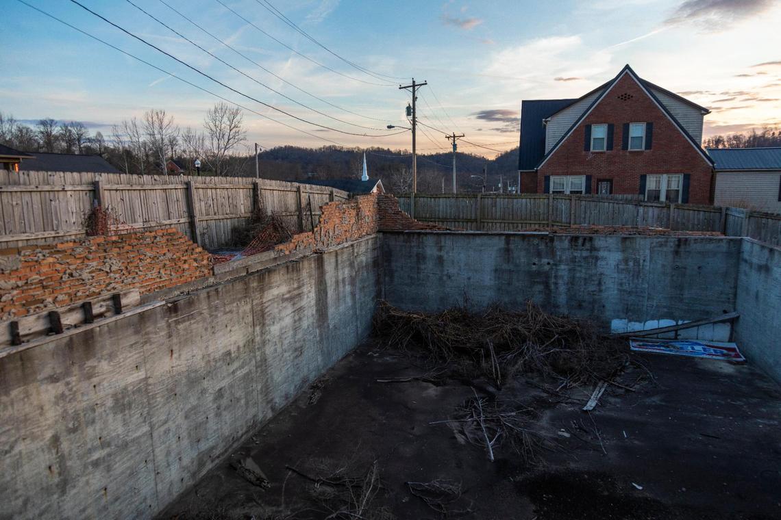 Bricks and the basement from a building that was damaged at the corner of Main Street and Court Street by the 2012 tornado and was never rebuilt in West Liberty, Ky., Wednesday, December 15, 2021.