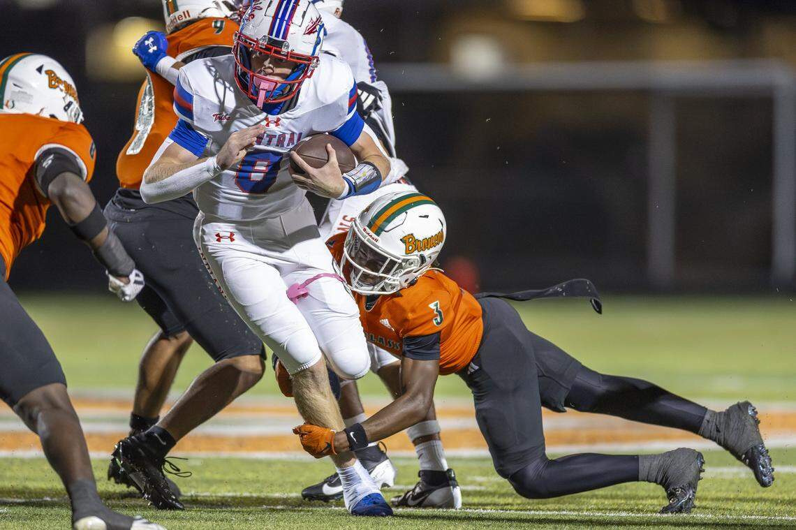 Frederick Douglass' Cionne Conn (3) wraps up Madison Central's Carson Herbst (8) during a game in Lexington, Ky., on Friday, Oct. 10, 2025.
