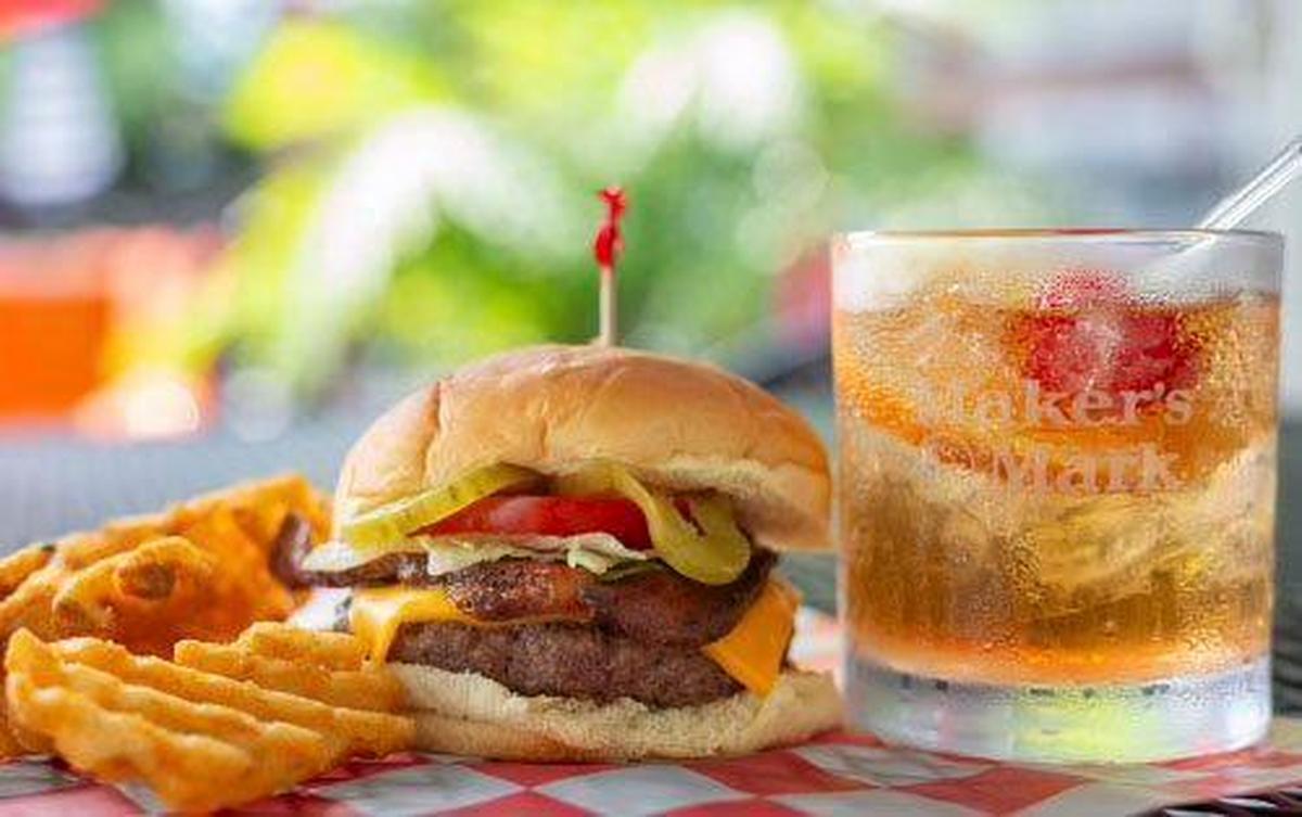A double cheeseburger with waffle fries from Rose & Jim’s Bar And Grill. The bar and restaurant has four handcrafted burgers: a traditional hamburger, cheeseburger, a bacon burger and a beer cheese bacon burger.