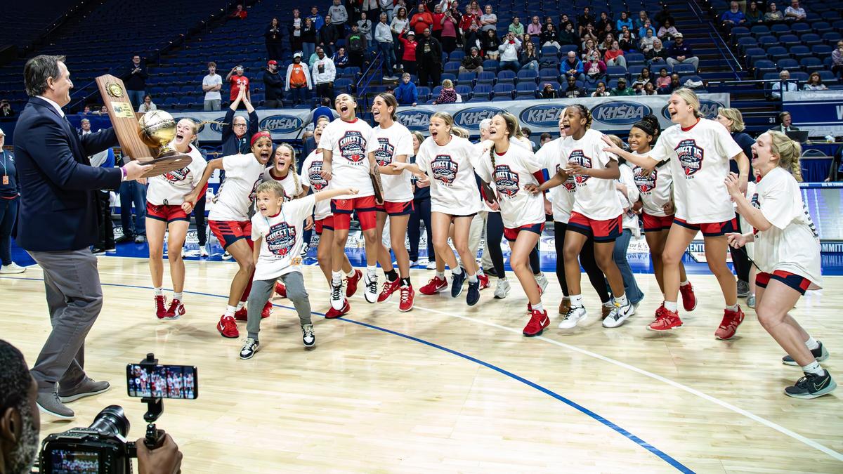 Sacred Heart players shout as they are presented with the 2025 state championship trophy after the Valkyries defeated George Rogers Clark in the finals at Rupp Arena on Saturday.