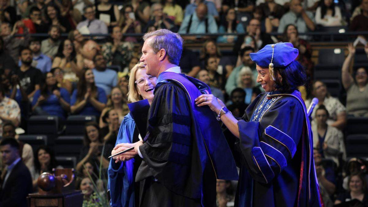 Kentucky Gov. Andy Beshear is given an honorary Doctor of Humane Letters degree on Sunday, May 10, 2026, at Berea College in Madison County, Kentucky. Berea College President Cheryl L. Nixon gave him a diploma as Provost Shewanee Howard-Baptiste draped a stole over his shoulders.