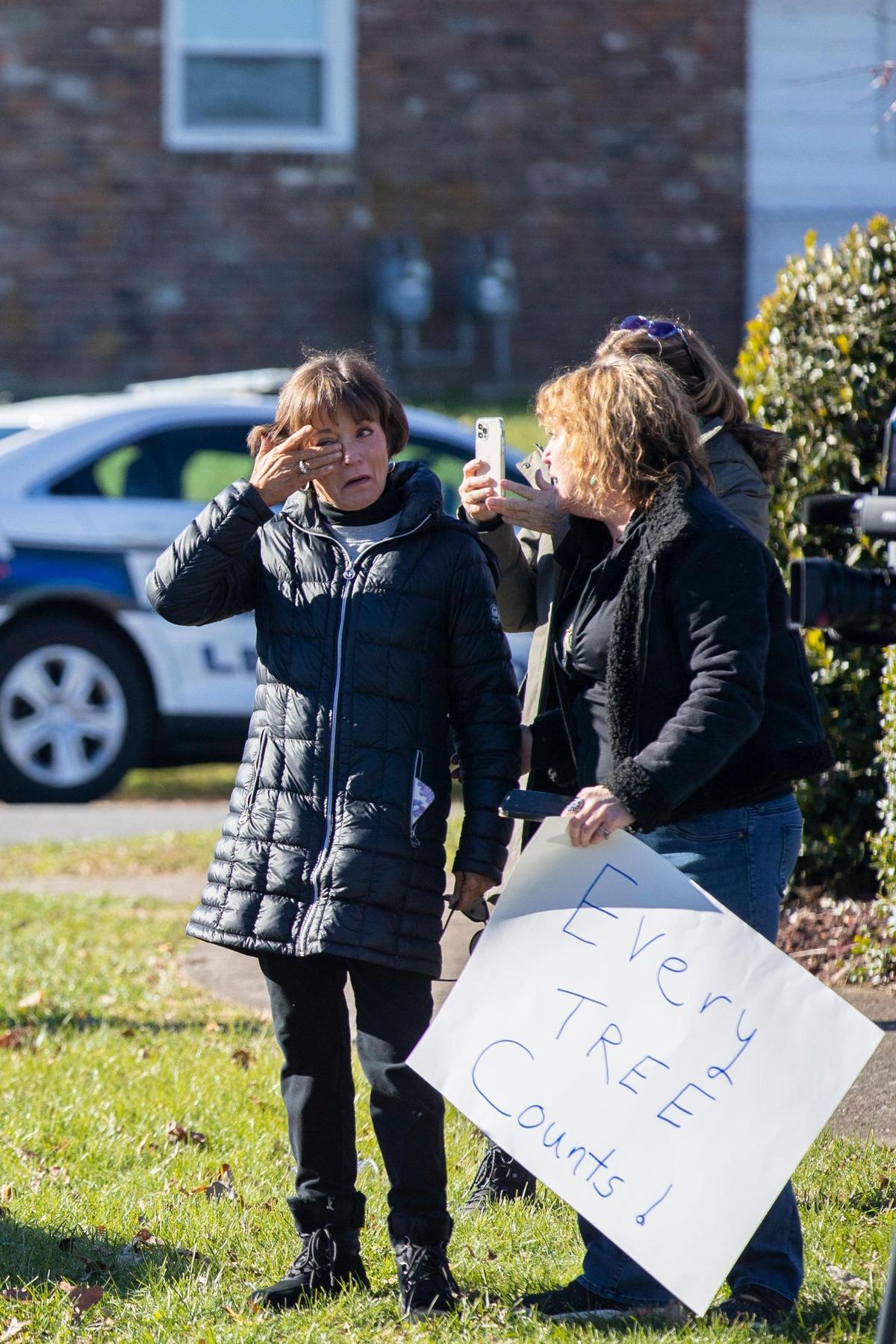 Protestors watched from the sidewalk as crews began clear-cutting trees along Lansdowne Drive.