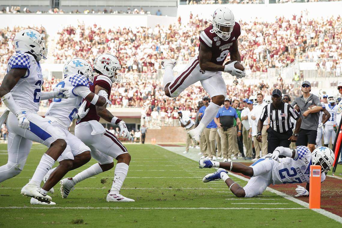 Mississippi State Bulldogs running back Kylin Hill (8) scores past Kentucky Wildcats defensive back Cedrick Dort Jr. (27) during their game at Davis Wade Stadium in Starkville, Miss., Saturday, Sept. 21, 2019.