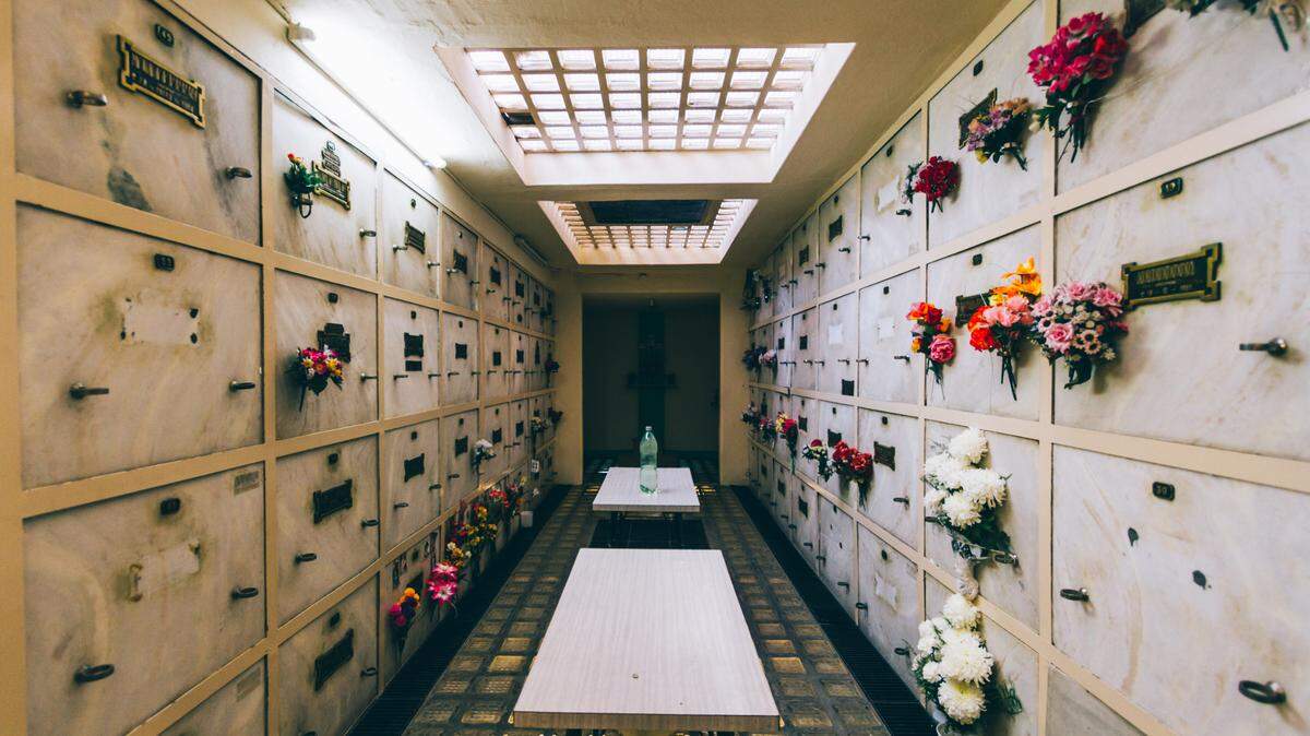 Niches on a cemetery’s cremation wall hold flowers. Stock image from Getty Images.