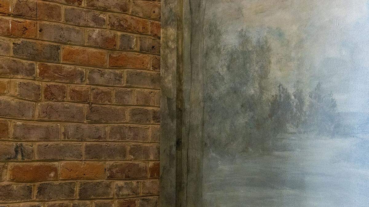 Exposed brick meets a hand-painted mural inside the bar area at Millstone, a new Lexington restaurant, located inside historic Dudley Square. Renovations started in January and owner Tyler Murray said they wanted to keep the integrity of the historic, 19th-century public schoolhouse that today is a multi-use commercial building.