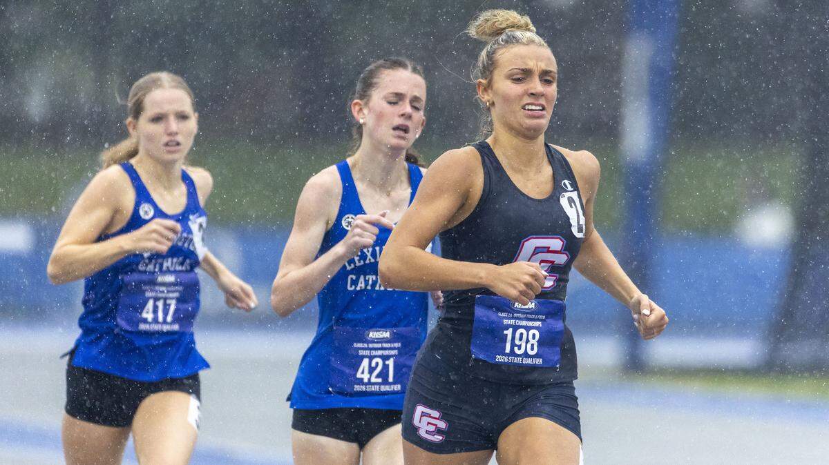 Calloway County's Jaidan Koch, right, won the girls 800 meter run ahead of Lexington Catholic's Abigail Turner, center, and Sarah Scott, left, in a rainstorm during the 2026 KHSAA Boys and Girls Class 2A State Track and Field Championships at the University of Kentucky track and field complex in Lexington, Ky., on Friday, May 22, 2026.
