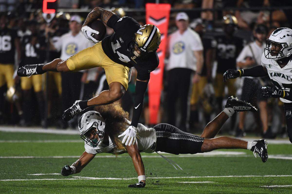 Vanderbilt Commodores wide receiver Will Sheppard (14) is tackled by Hawaii Warriors defensive back Peter Manuma (1) after a reception during the second half at FirstBank Stadium in the Commodores’ 35-28 win on August 26, 2023. (Christopher Hanewinckel-USA TODAY Sports)