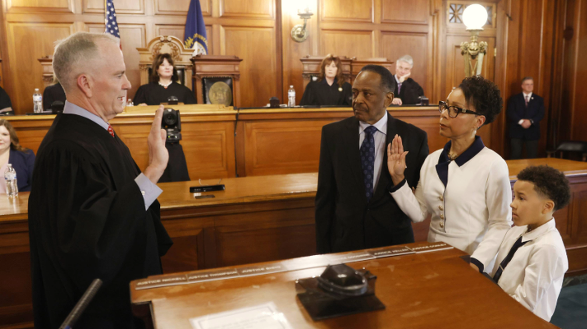 Justice Pamela R. Goodwine takes the oath of office from Chief Justice Laurance B. VanMeter (ret.) on April 18, 2025, in the Supreme Court Courtroom at the Capitol. She is joined by her husband, Lee A. Padgett Jr., and great-grandson, Beckham Mourning