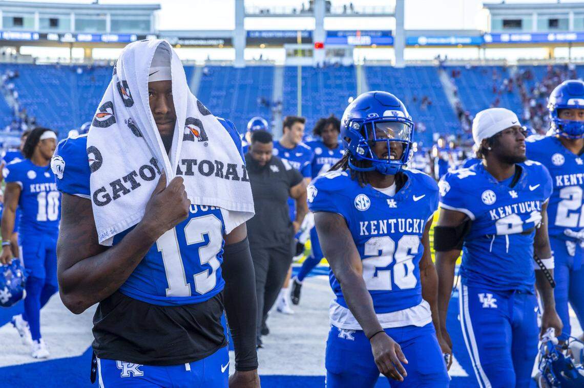 Kentucky’s Fred Farrier (13) and Jason Patterson (26) walk off the field after a loss to South Carolina at Kroger Field on Saturday.