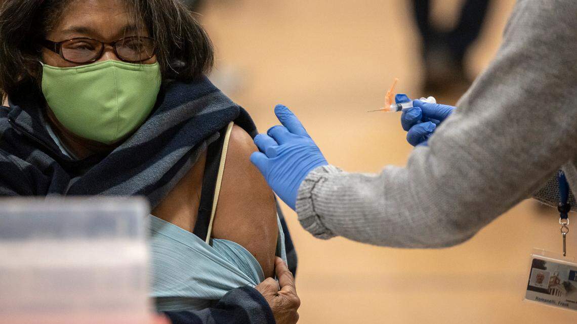 Doris Benbow, of Lexington, is administered the COVID-19 vaccine by Frank Romanelli at a Lexington-Fayette County Health Department vaccination clinic at Consolidated Baptist Church in Lexington, Ky., on Wednesday, Feb. 3, 2021.