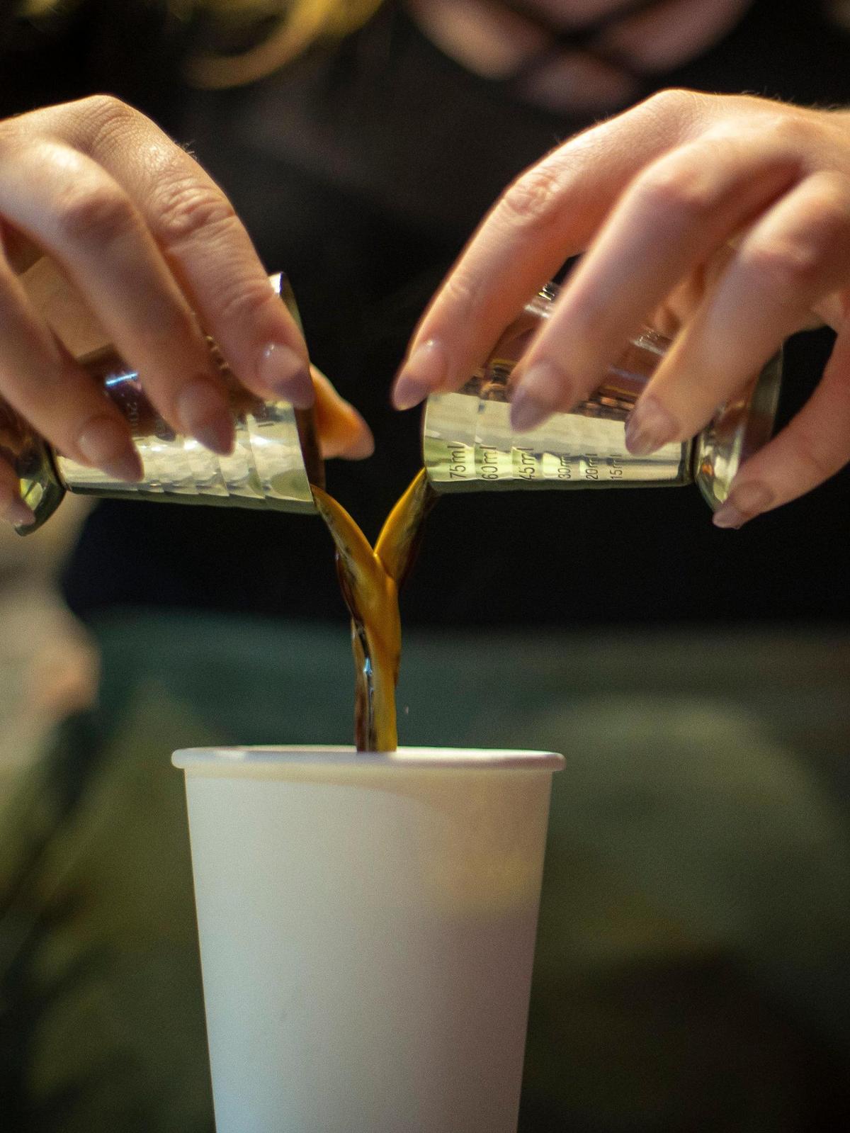 Audra Jones, a manager at The Creatures’ Cauldron Cafe makes a drink at the cafe on Thursday, Sept. 22, 2022. Coffee can be added to all the drinks they serve.