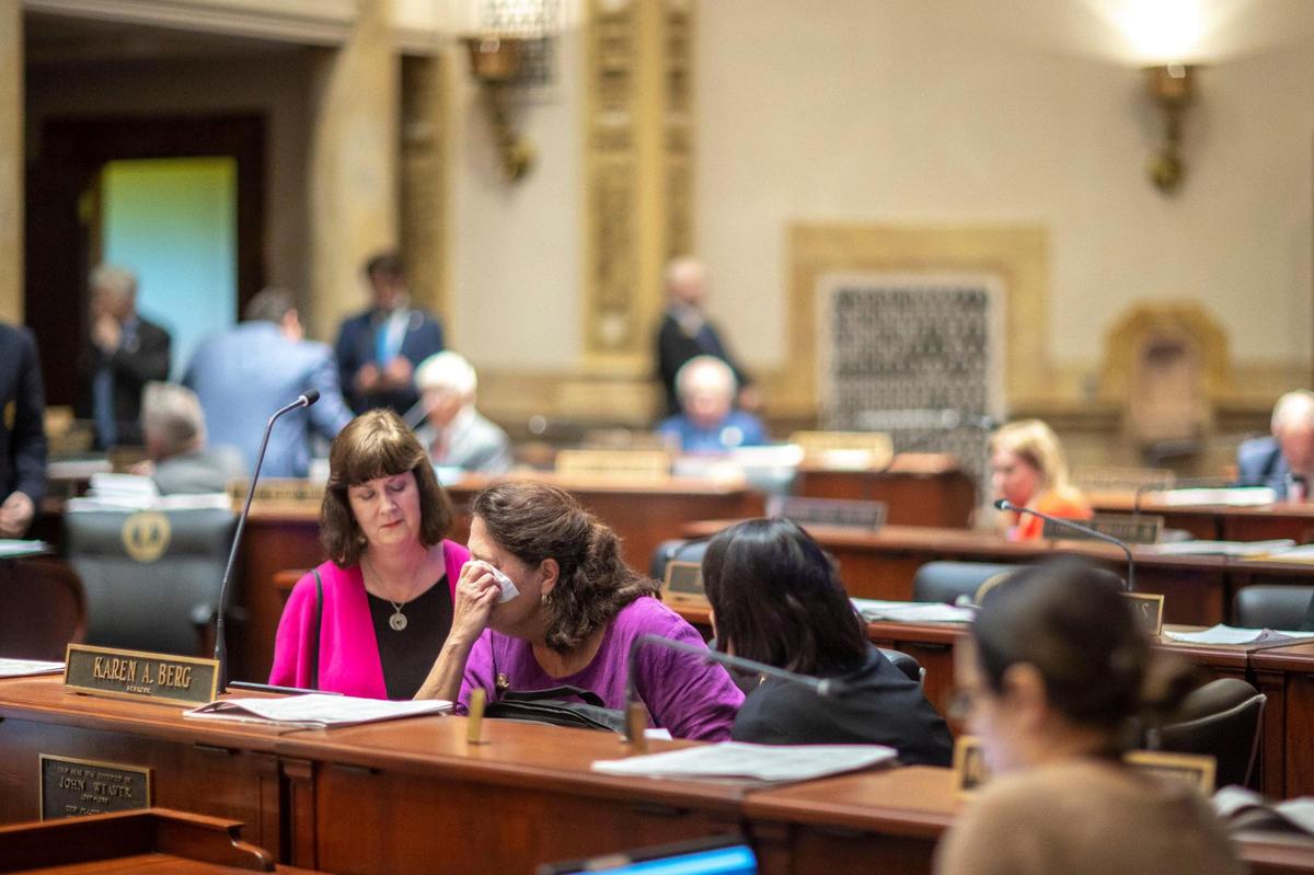 Kentucky Sen. Karen Berg, D-Louisville, is consoled by former state legislator Patti Minter, left, and Rep. Tina Bojanowski, D-Louisville, after SB 150 passed the Senate, 29-6, at the Kentucky state Capitol on Thursday, Feb. 16, 2023. The bill would allow teachers to choose whether or not to use a student’s pronouns.