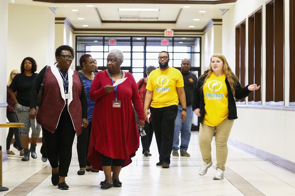 Student Grace Allen, 17, right, leads a tour of the campus Thursday during an open house at Success Academy in Lexington.