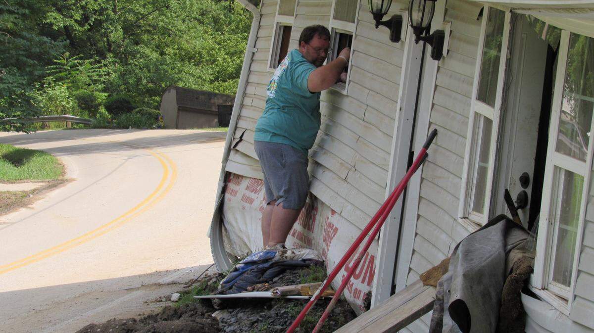 Reggie Ritchie stands outside his wrecked house near the Perry-Knott County line a few days after the deadly July 28, 2022 flooding in Eastern Kentucky. His wife was inside trying to salvage items and handing them to him out the window.