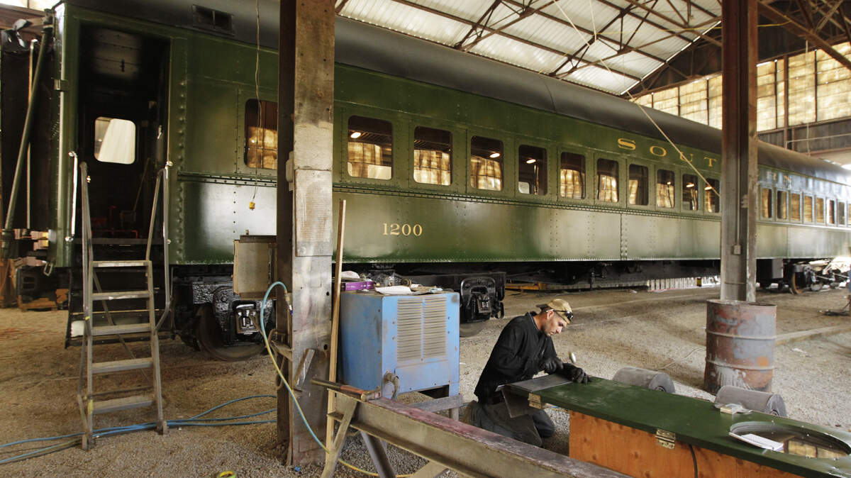 Dustin Boyle worked last week on a door of a segregation-era rail car being restored in McCreary County by Wasatch Railroad Contractors of Wyoming. It is destined for a new Smithsonian museum in Washington.