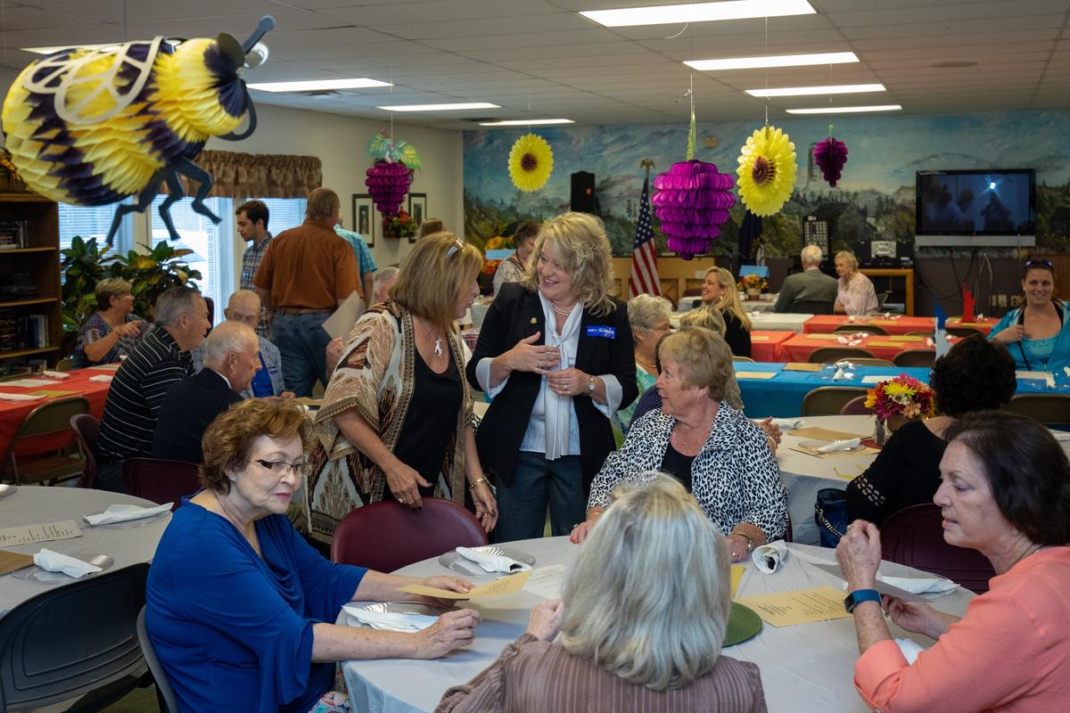 Dana Dadisman, standing left, and Bobbi Jo Lewis talked before the first ever Gayle Dadisman Memorial Dinner on  Thursday Oct. 4, 2018 in Lawrenceburg, Ky.