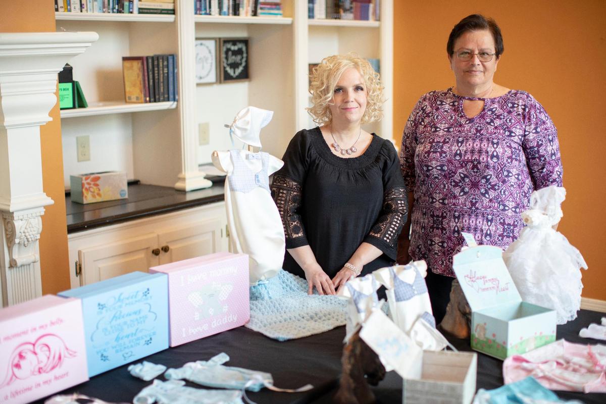Tammy Marcum, founder of non-profit Haley’s Angels, with her friend and helper Sandra Turner pose for a portrait at Journey Church in Versailles, Ky., Saturday, December 5, 2020. Marcum lost her daughter 15 years ago at 22 weeks. A month after her loss she started a non-profit to help her deal with the grief. The hospital only had clothes for newborn babies that would not fit her preterm infant. She started to sew outfits so that no other family grieving would struggle to find an outfit for their child. “In each box a card goes in there that talks about Haley, so everyone knows that they are getting this from a parent that has lost a baby and I’ve been there,” Marcum said.