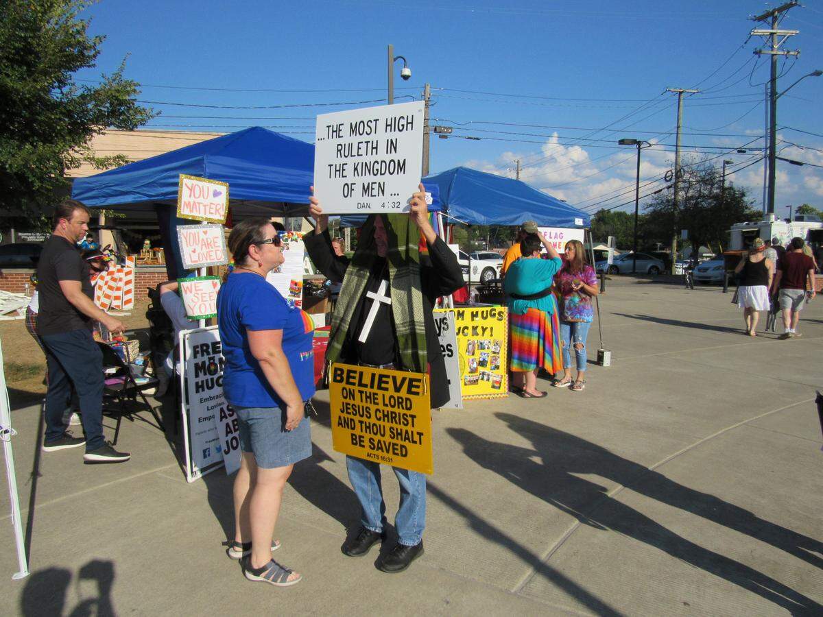 Christina Briggs, left, with an LGBTQ+ support group called Free Mom Hugs, talked with a man who was protesting the first public pride event held in Somerset on Oct. 5, 2019.