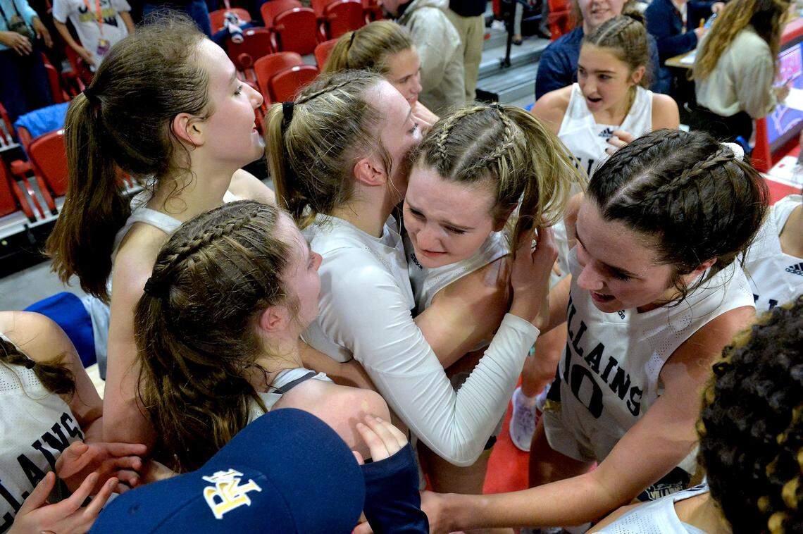 Adelaide Jernigan (10) celebrates a North Carolina Class 1A girls basketball state championship with Bishop McGuinness teammates in 2022.