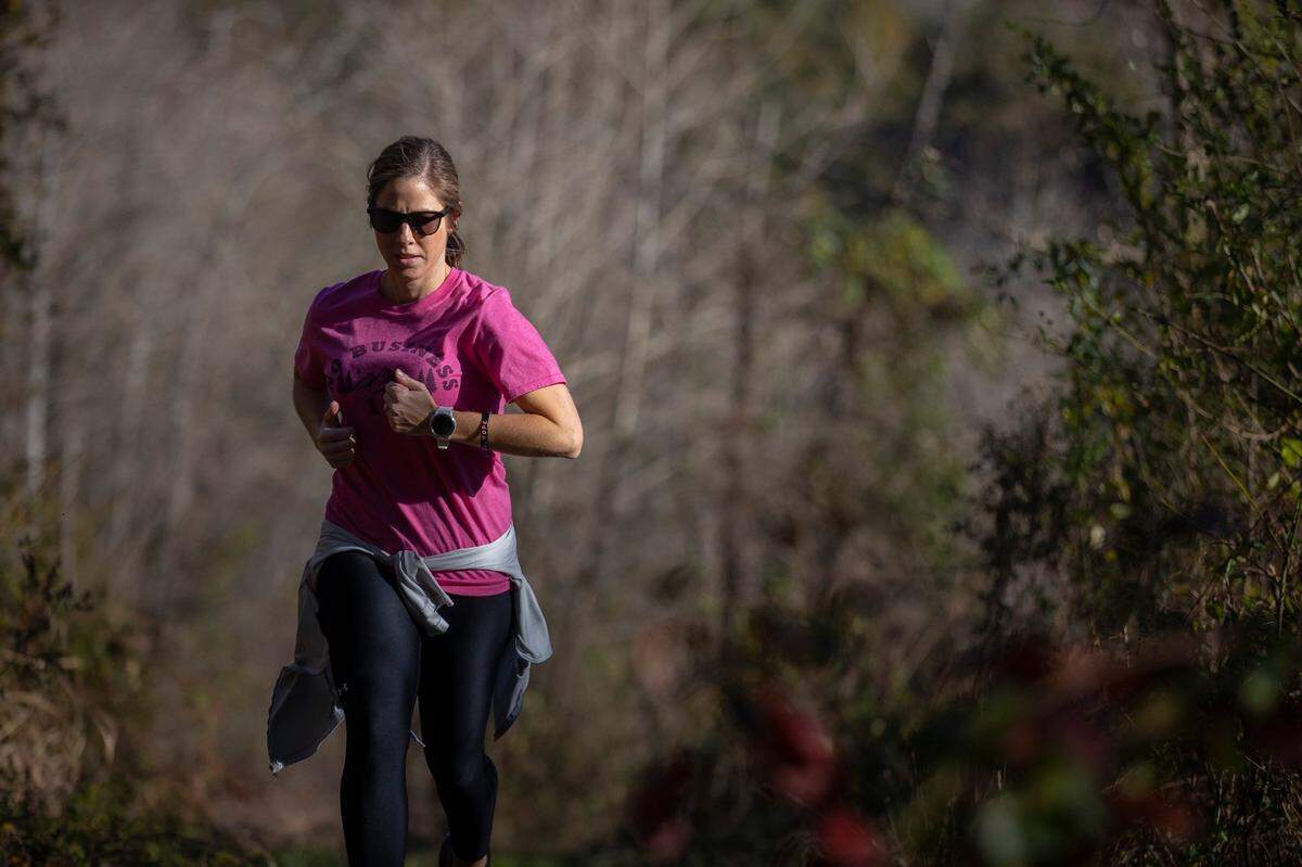 Wayne County High School nurse Lindsey Sexton runs on a trail in the Big South Fork National River and Recreation Area. Last year, some three months after having a double mastectomy, Sexton, a 36-year-old mother of three, ran a 102-mile ultramarathon.
