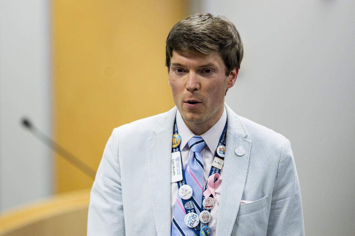 Tyler Murphy, chair of the board, talks with attendees during a school board meeting on Monday, Aug. 18, 2025, at Fayette County Public Schools Central Office in Lexington, Ky. 
