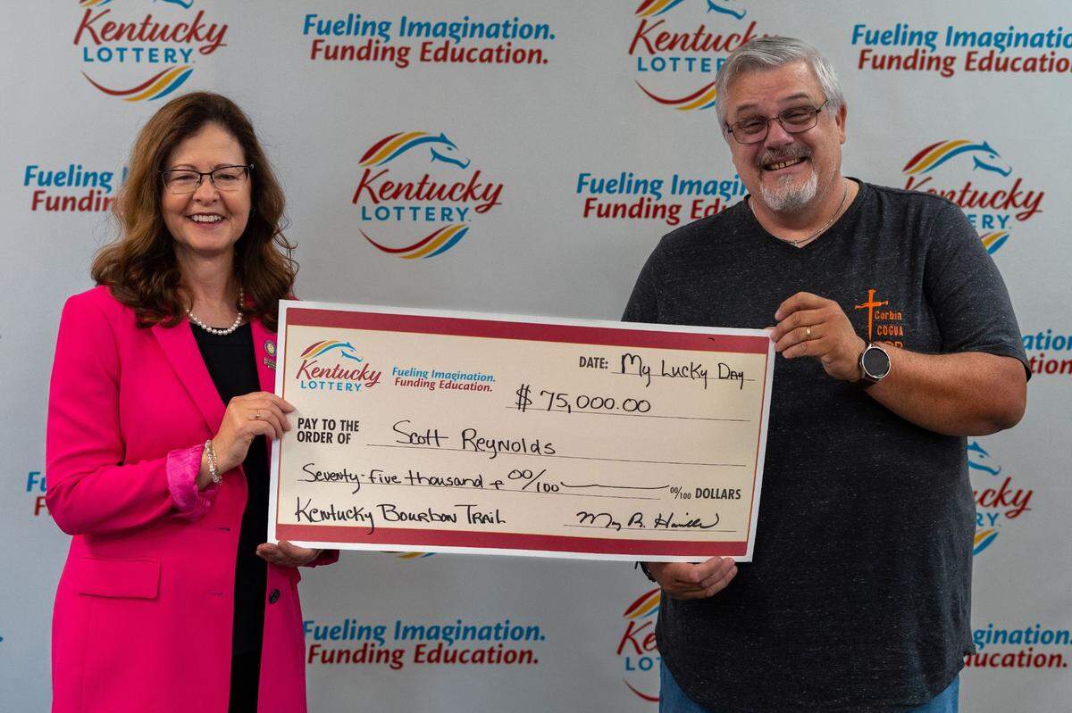 Jackpot winner Scott Reynolds is pictured here with Kentucky Lottery President Mary Harville. Reynolds and his wife planning on using their $75,000 prize to purchase a new church van. Reynolds is a pastor in Corbin, Ky.