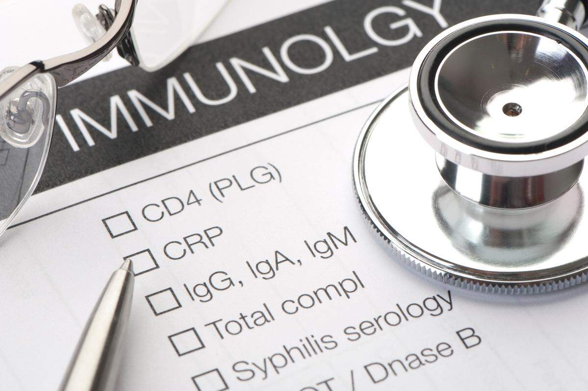 On a medical record form, a pen and stethoscope rest on the section where Immunology blood tests to be ordered are recorded. These blood tests relate mainly to sexually transmitted diseases and HIV/AIDS.