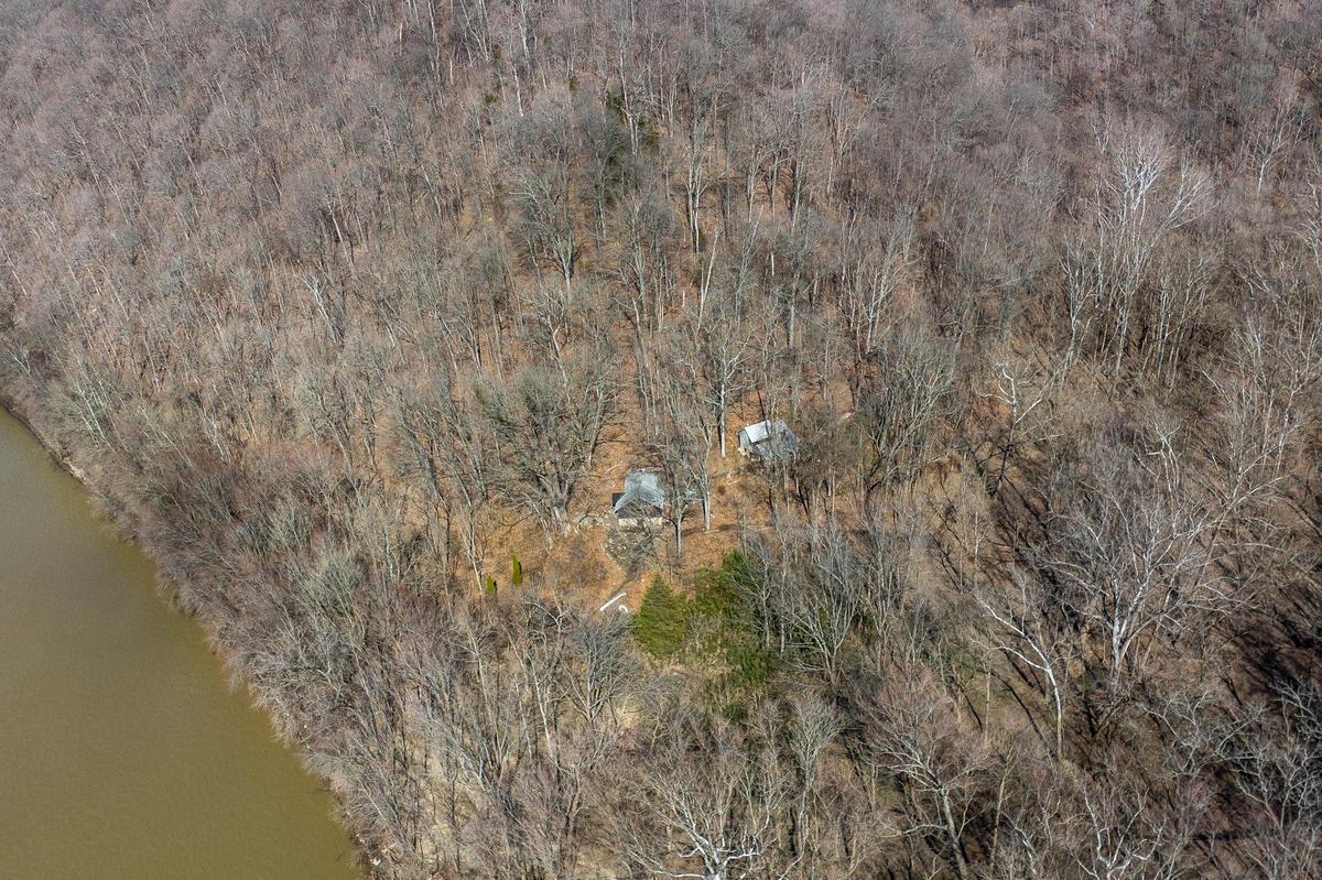 The residence, left, and studio at Payne Hollow are photographed by the Ohio River in Trimble County, Ky., on Thursday, March 6, 2025. Harlan and Anna Hubbard lived off their land in a very remote and sustainable way for about 40 years at Payne Hollow.