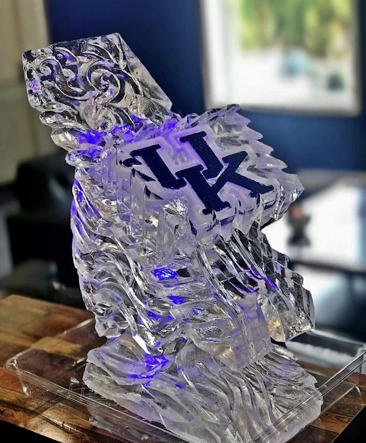 Seasons Catering specializes in ice sculptures and ice luges. You pour drinks down the ice and into a glass. It cools instantly. You can get the UK logo or other items custom sculpted.