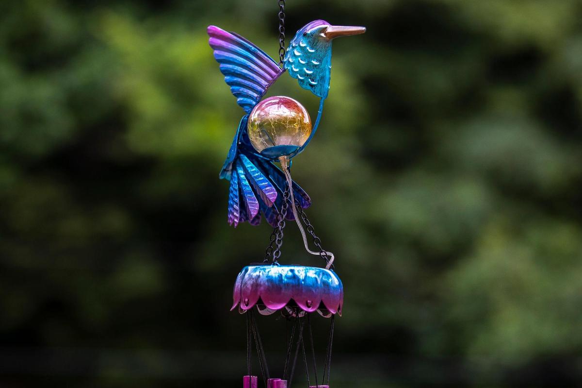 A wind chime hangs at the memorial for Vanessa Baker near the site of where she was swept away from her home on Lower River Caney by flood waters last summer.
