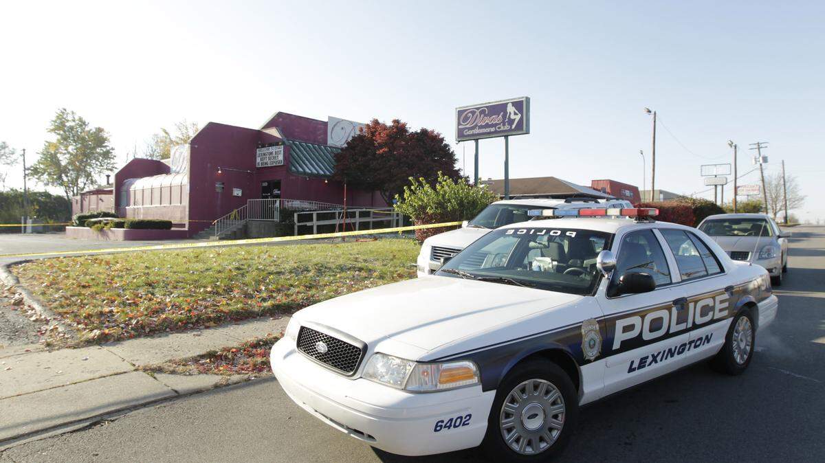 Police cars and an investigation unit parked around Divas Gentlemen's Club after an overnight shooting in Lexington, Ky., on Nov. 13, 2013.  Photo by Pablo Alcala | Staff 
