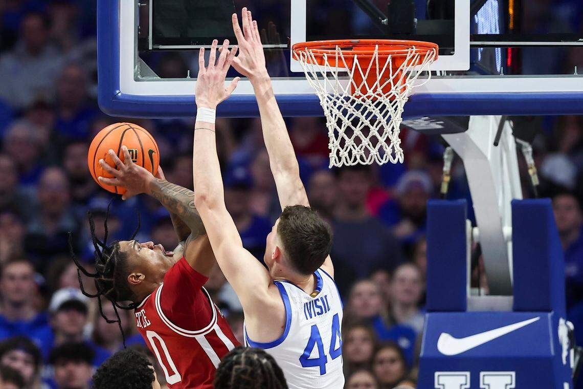 Arkansas’ Khalif Battle (0) drives to the basket against Kentucky’s Zvonimir Ivisic (44) during Saturday’s game at Rupp Arena.