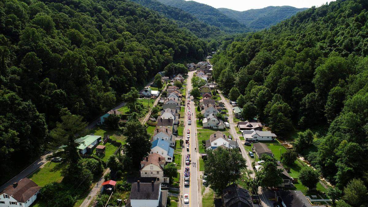 Participants line up for a Fourth of July parade along Main Street in Lynch, Ky., Saturday, July 3, 2021. The city of Lynch was established as a coal mining town in 1917. At one point it was home to about 10,000 residents. Today, the population is less than 600.