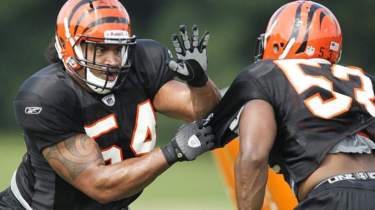 DeQuin Evans, a former Kentucky linebacker signed as a free agent this season, ran a drill with Cincinnati Bengals teammate Vincent Rey during a July 31 practice at Toyota Stadium in Georgetown. Evans played in 25 games for UK, including 20 starts.